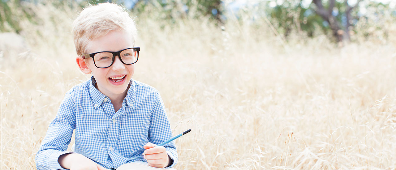 child writing outside